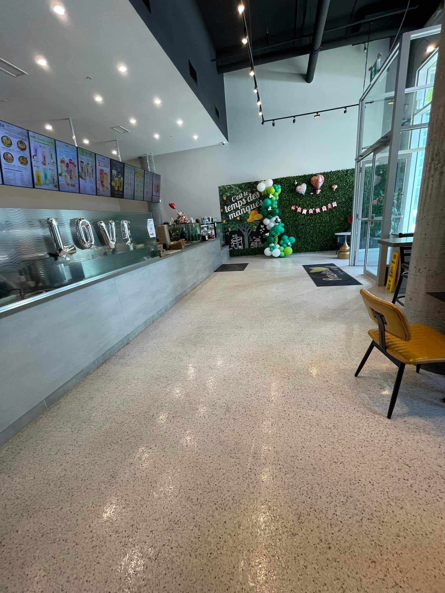 A long hallway in a restaurant with a christmas tree on the wall.