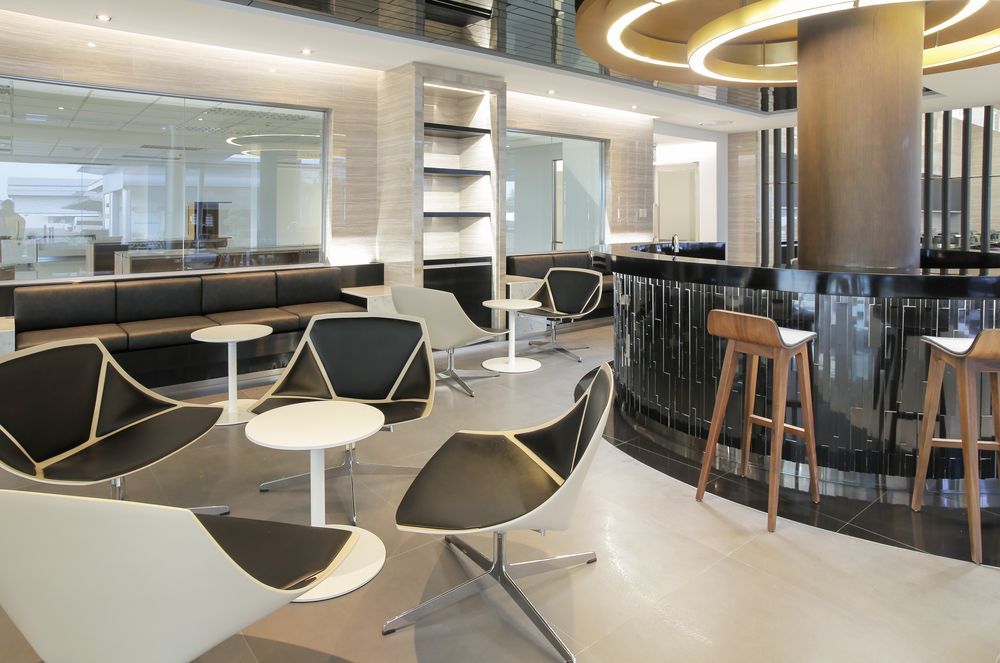 There are many chairs and tables in this room.