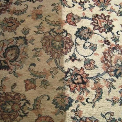 A close up of a rug with flowers on it