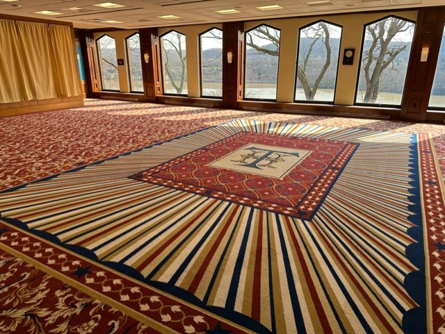A large room with a large rug on the floor