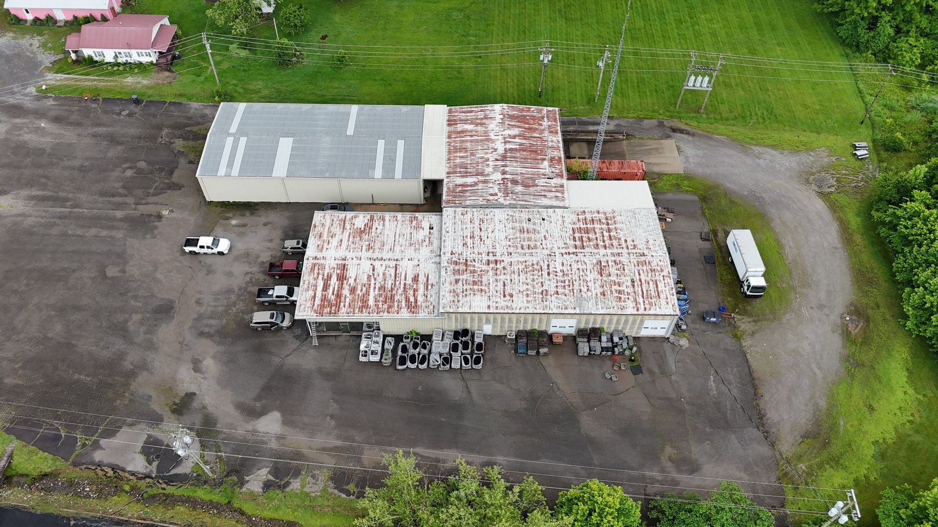 An aerial view of a large building with a lot of cars parked in front of it.