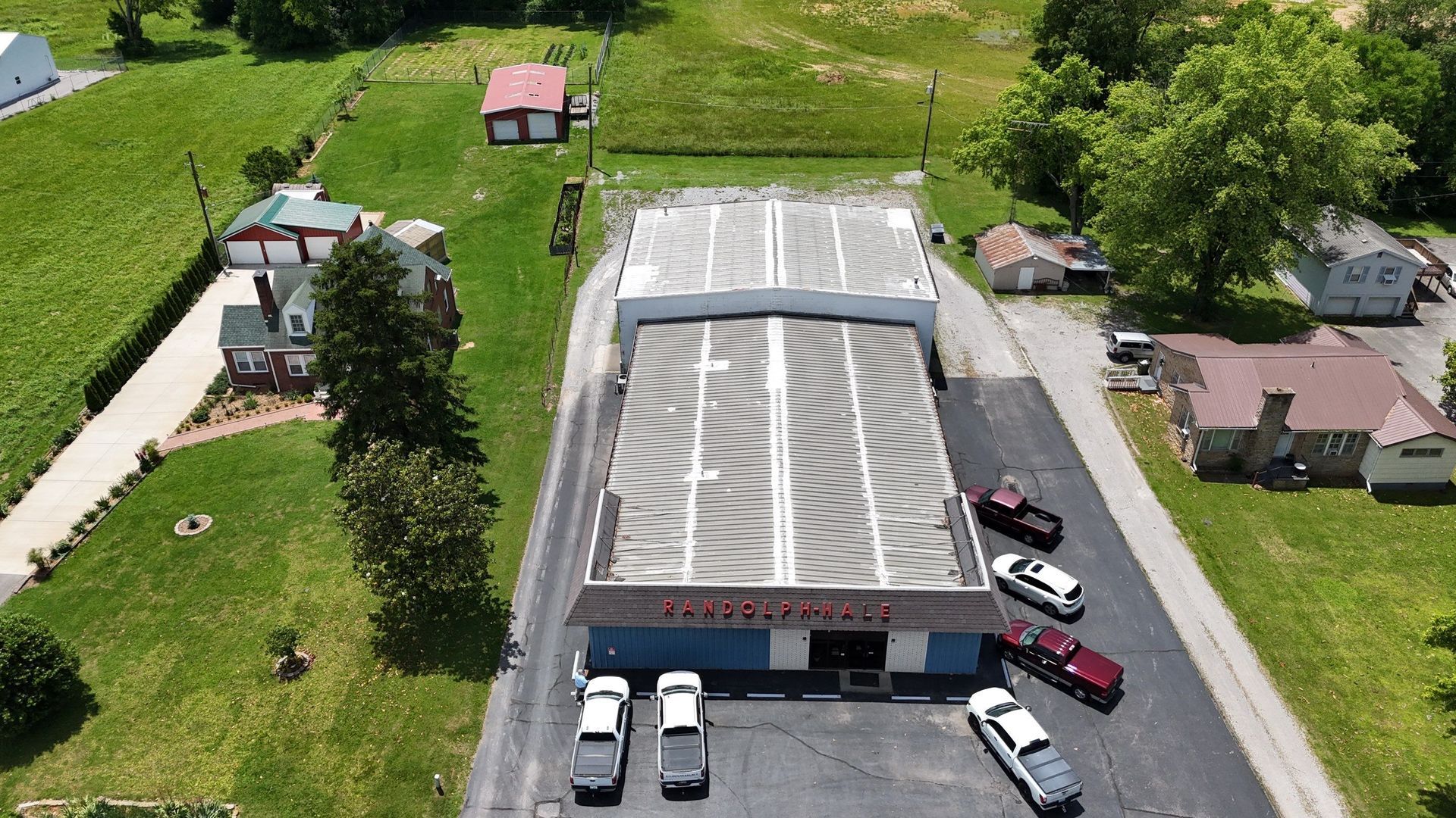 An aerial view of a building with cars parked in front of it