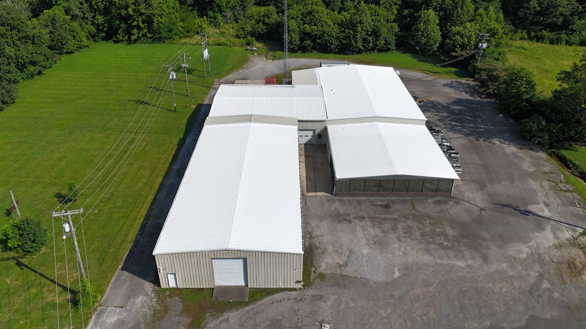 An aerial view of a large building with a white roof