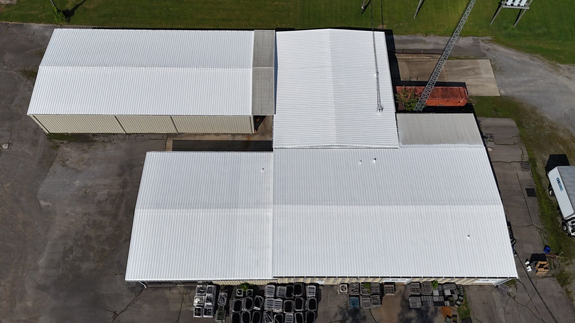 An aerial view of a large white tent on top of a building.