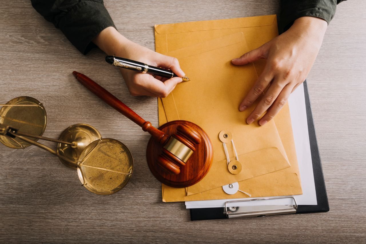 envelopes, wooden gavel on a table in a courtroom