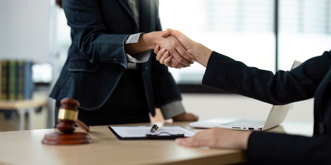 Professional Lawyers Shaking Hands Over a Legal Agreement