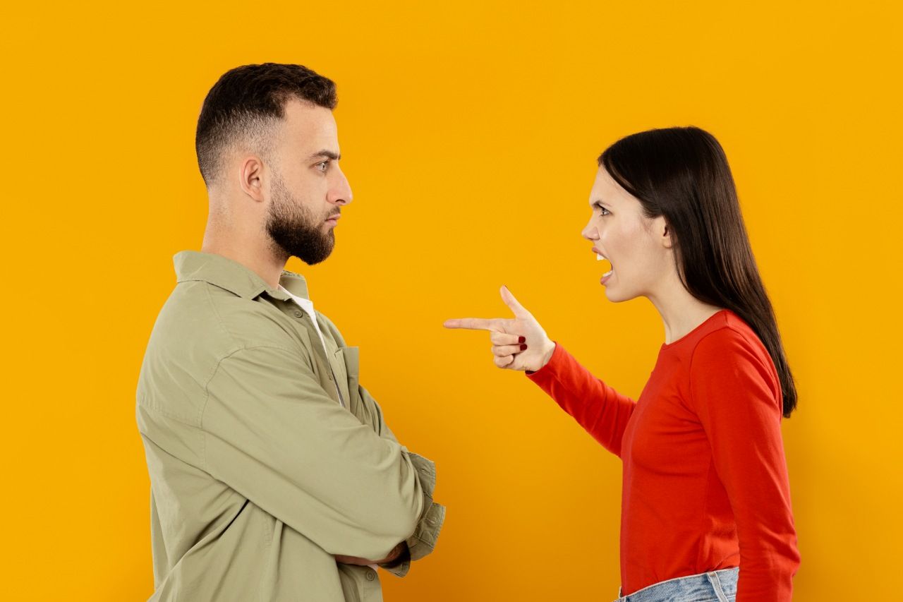 couple stands facing each other in a tense moment