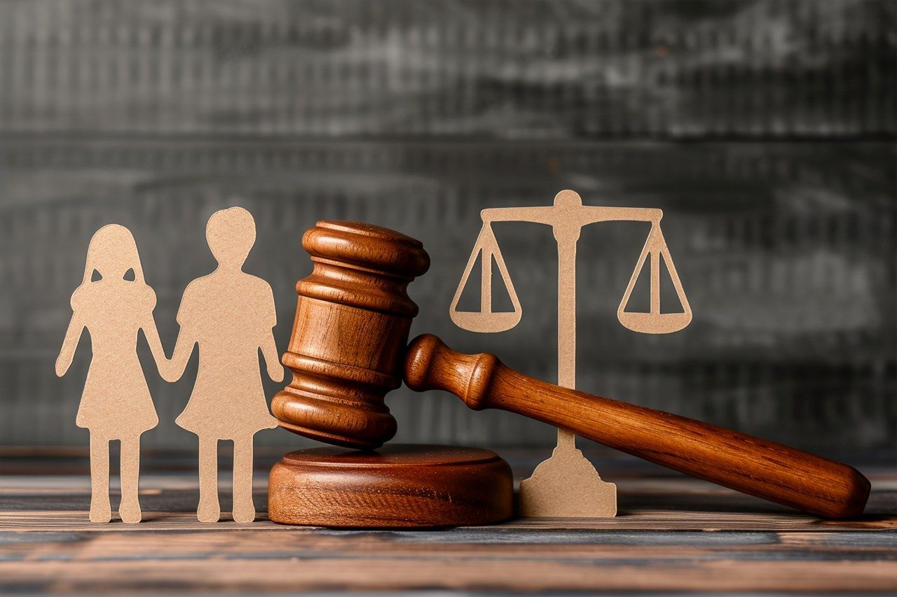 judge gavel with cardboard cut out of a couple