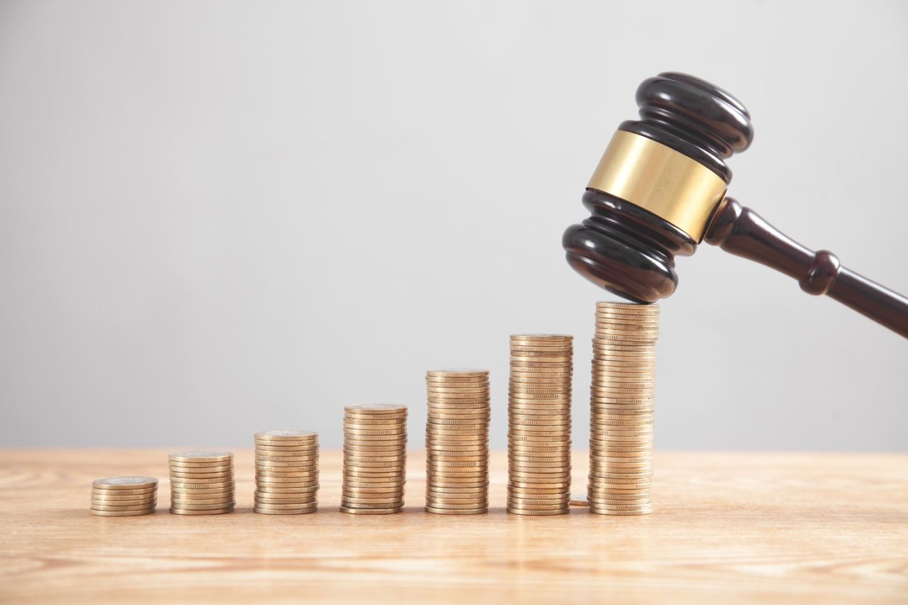 Stack of coins with judge gavel