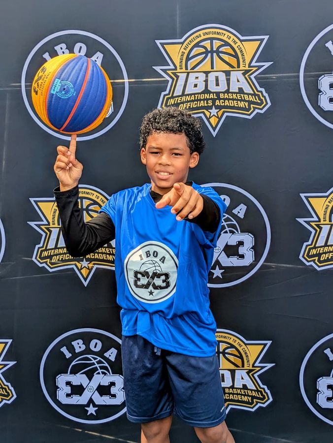 IBOA 3x3 Player pointing with a FIBA 3x3 ball.