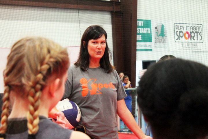 Photo of Coach Julie coaching the volleyball team