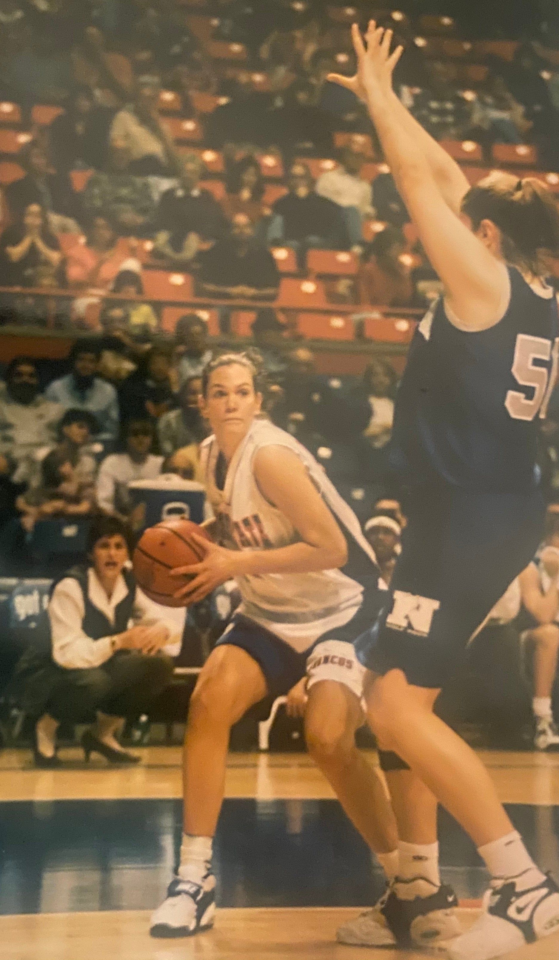 A female basketball player with the number 5 on her jersey