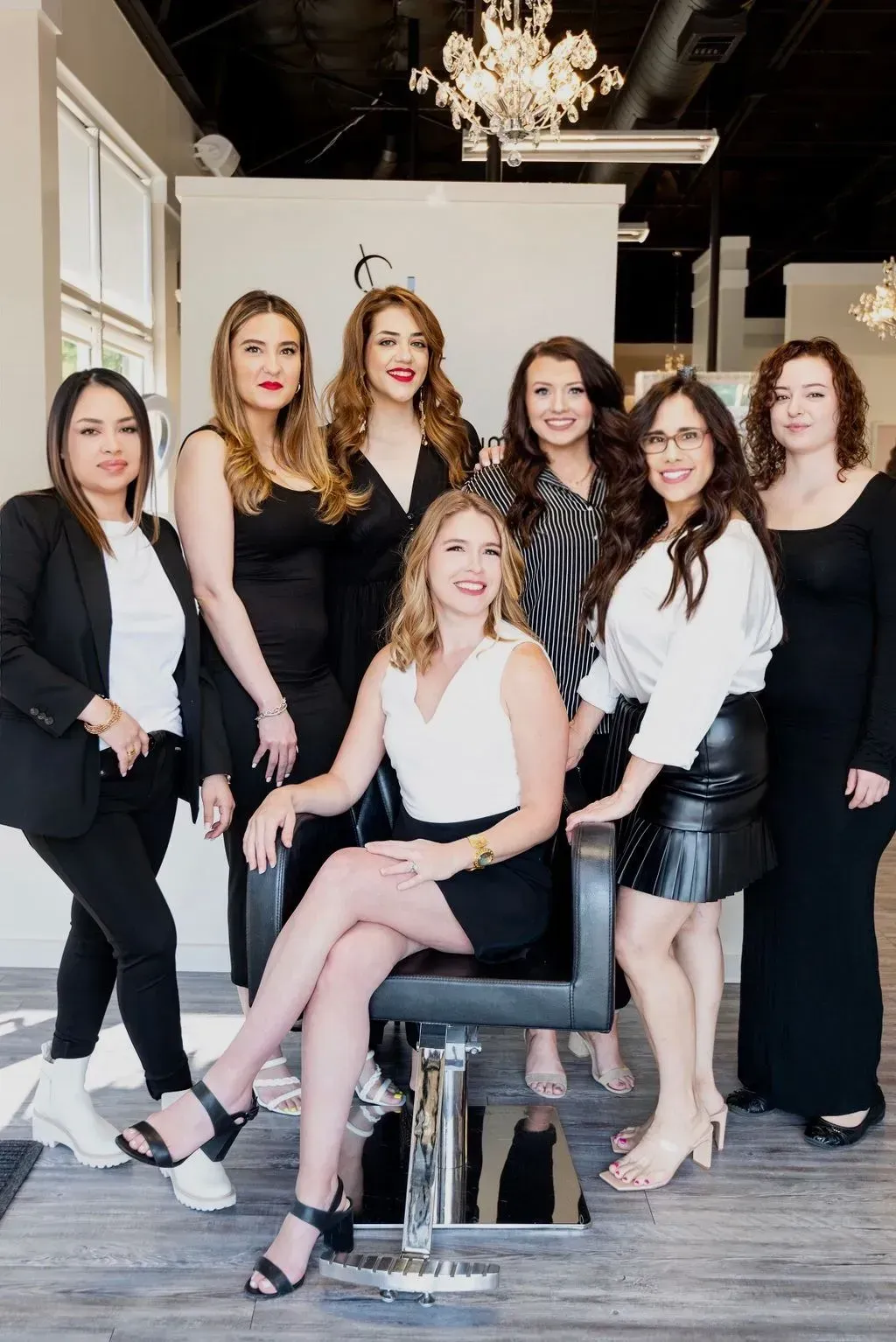Slide show of the team of smiling hairstylists surrounding Kristina Bynum, owner of Salon Le Volume in Frisco, Tx.