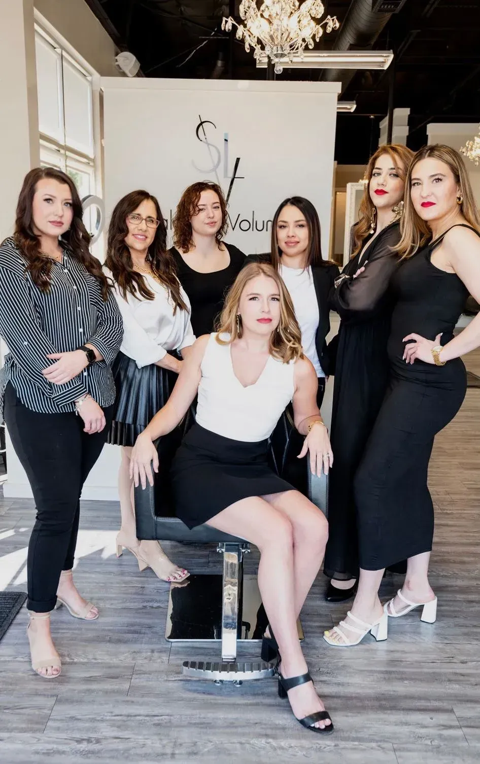 Part of slide show of hairstylists with demure expressions, including Kristina Bynum, owner of Salon Le Volume in Frisco, Tx.