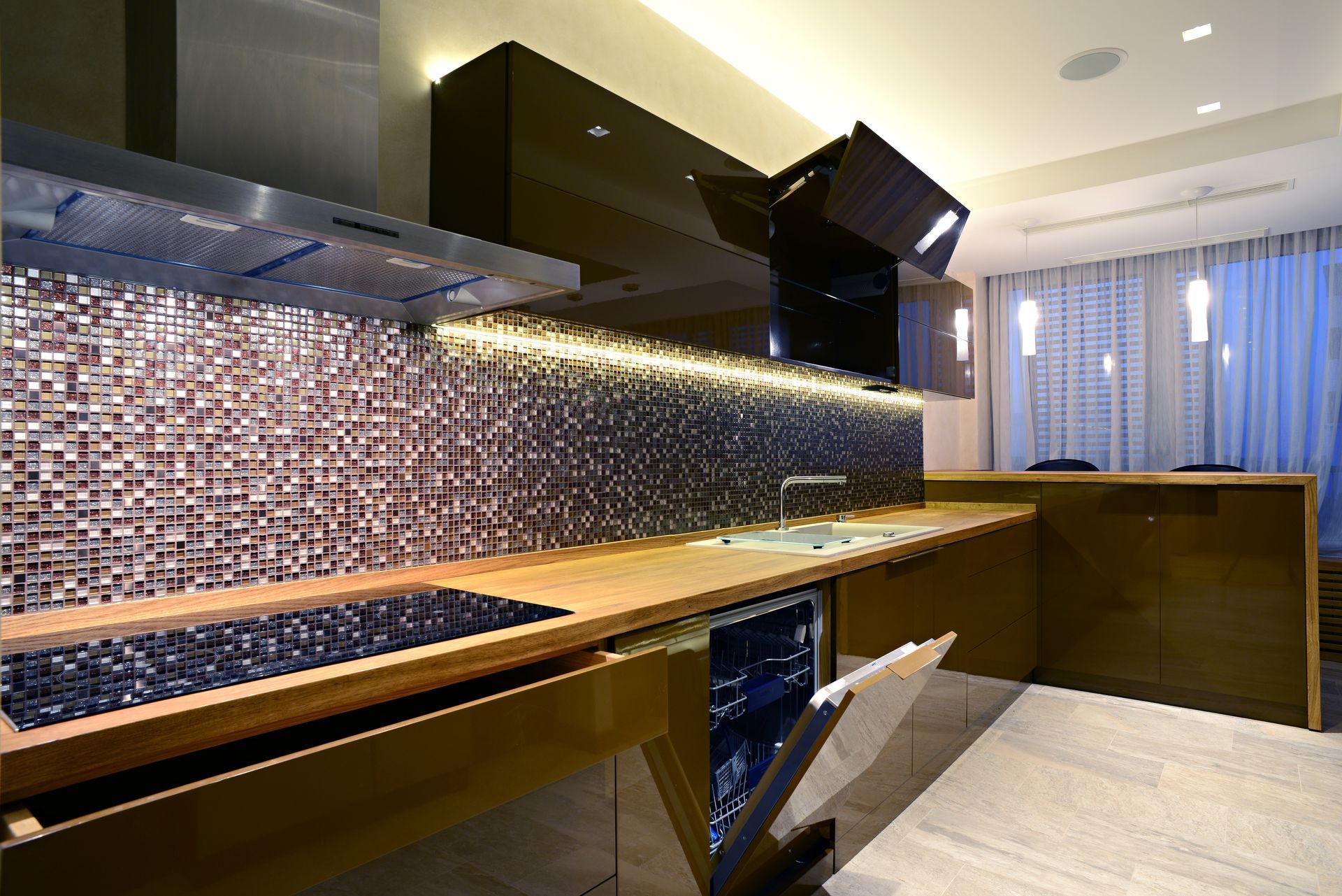 Modern kitchen with a mosaic tile backsplash, dark cabinets, and wooden countertops.