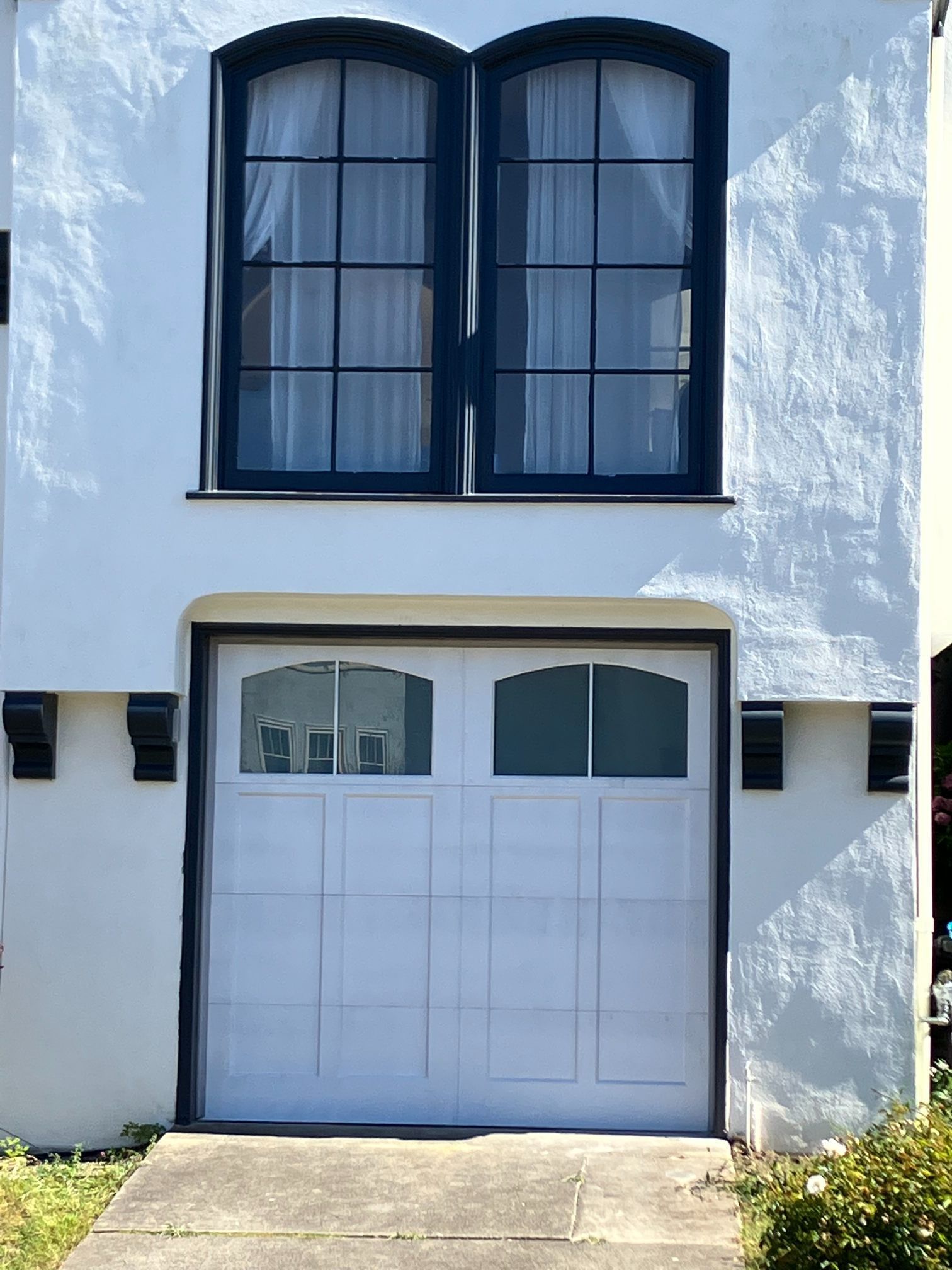 The garage door is made of wood and has a lot of windows.