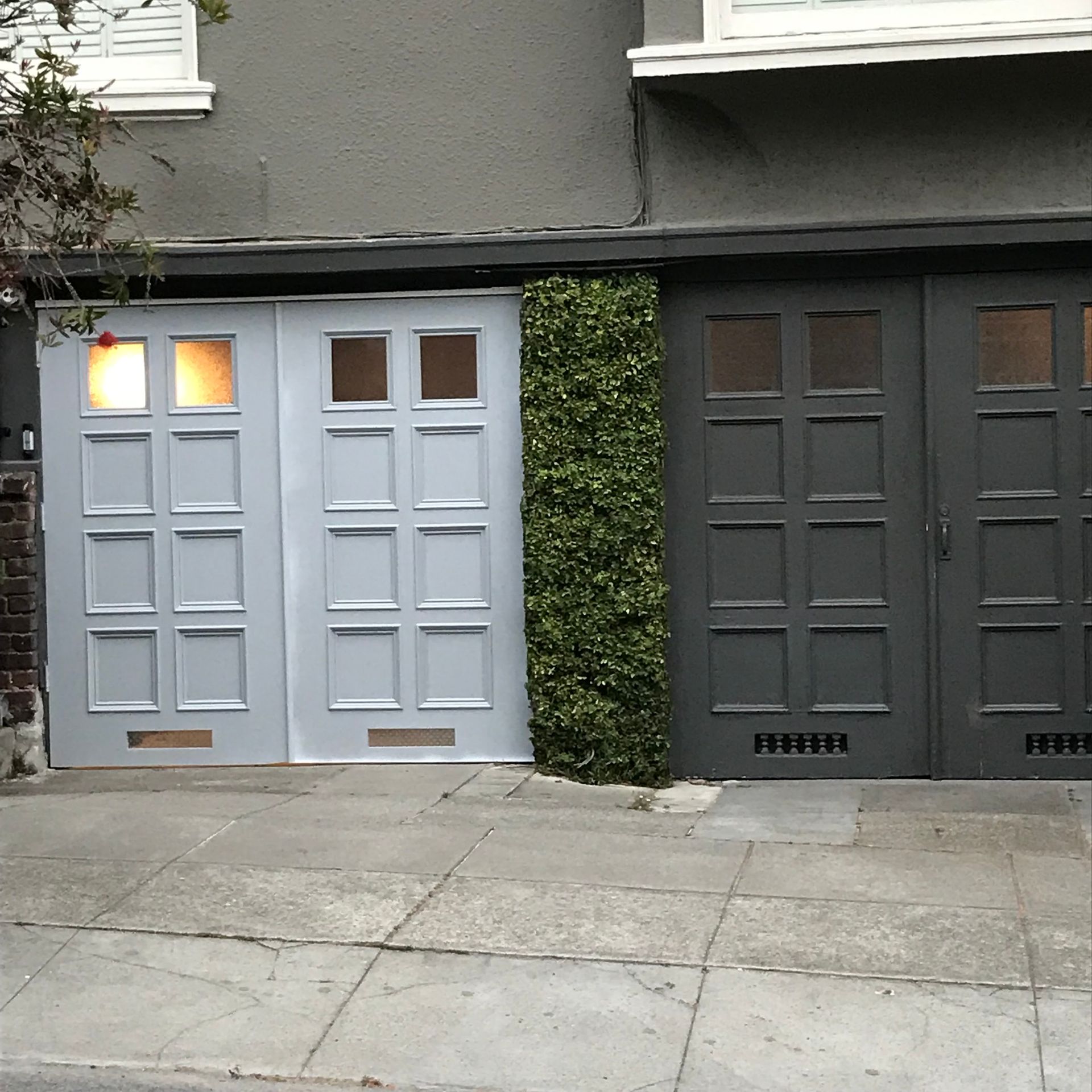 A couple of garage doors on the side of a building