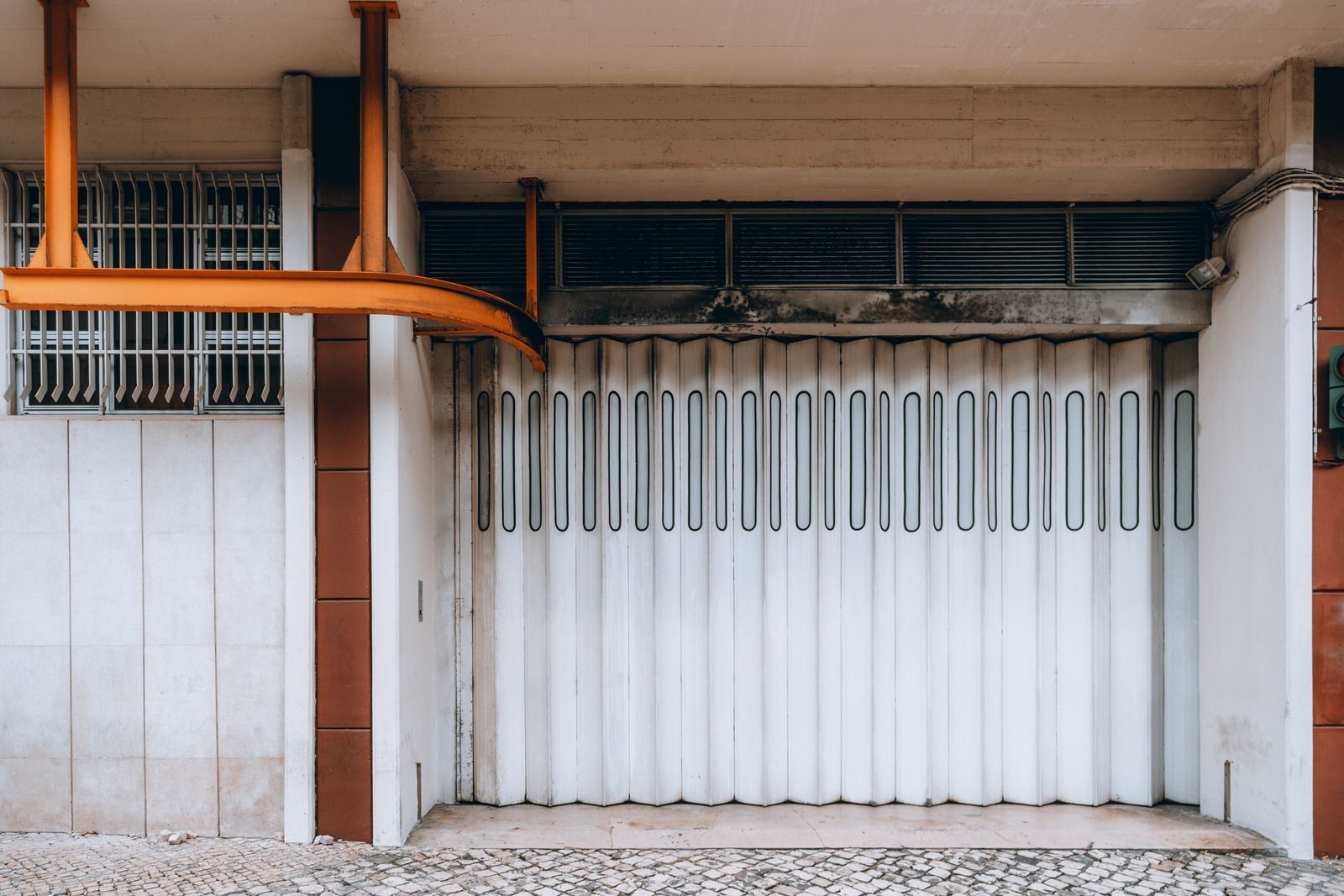A white garage door is closed on a building.