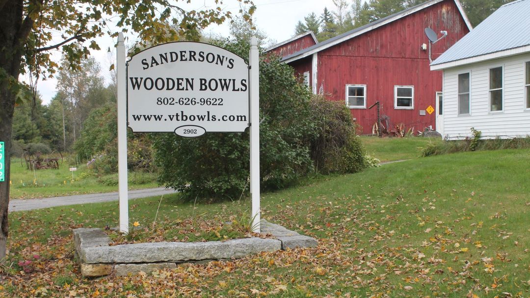 Sanderson's white house with a red barn in the background in East Burke, VT.