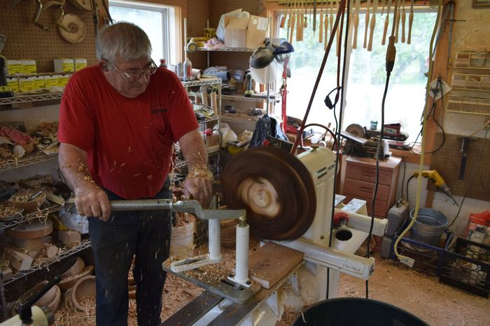 Sam Sanderson working on a lathe in the workshop in East Burke, VT.