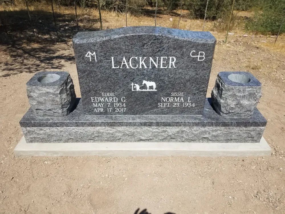 Grey stone headstone with kneeling prayer engraving