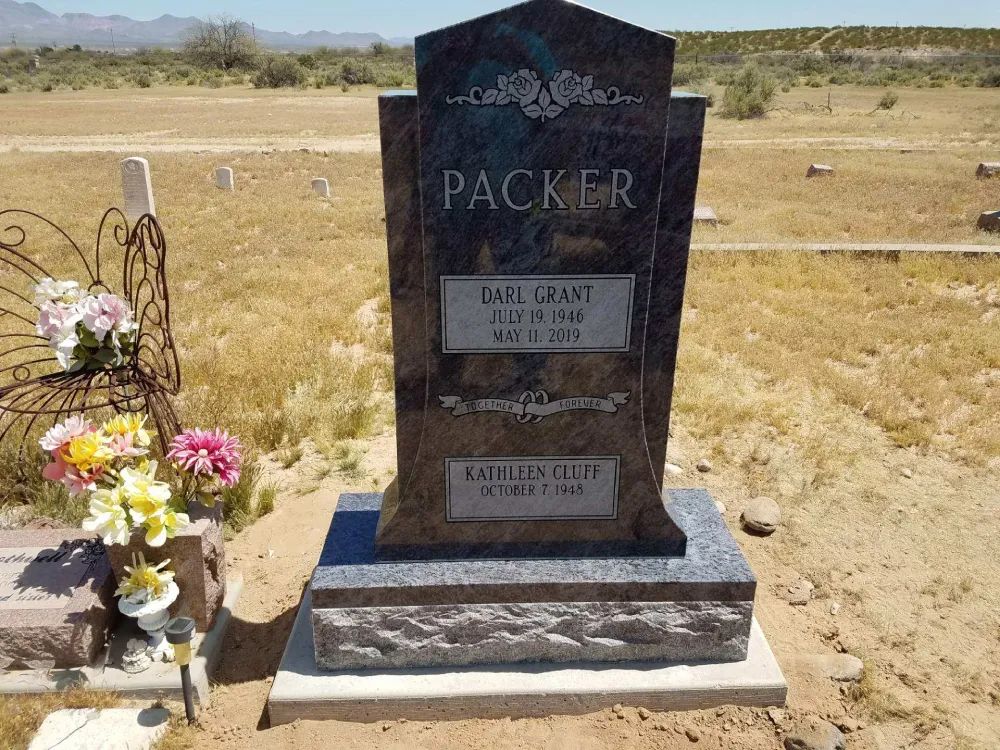 upright headstone with two persons and roses