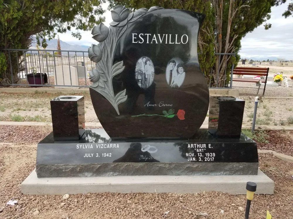 black headstone with climbing roses