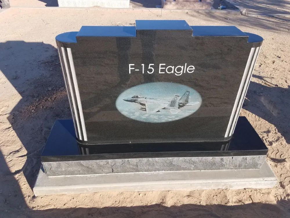 Upright black headstone with F-15 engraving