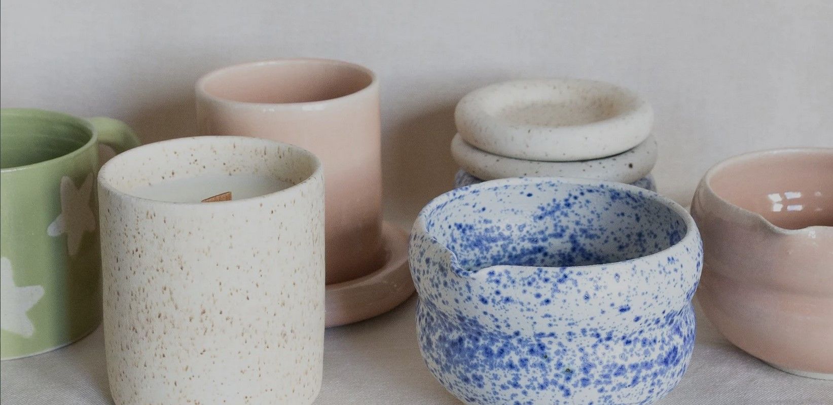 Collection of ceramic mugs and vases.