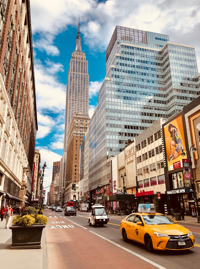 A busy city street surrounded by skysrcapers.