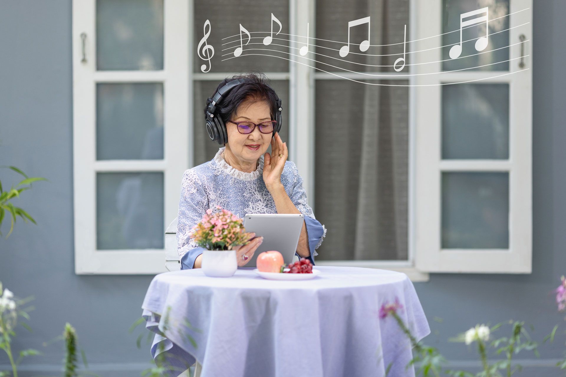 Senior woman is listen music and pose share good news at social media via computer tablet