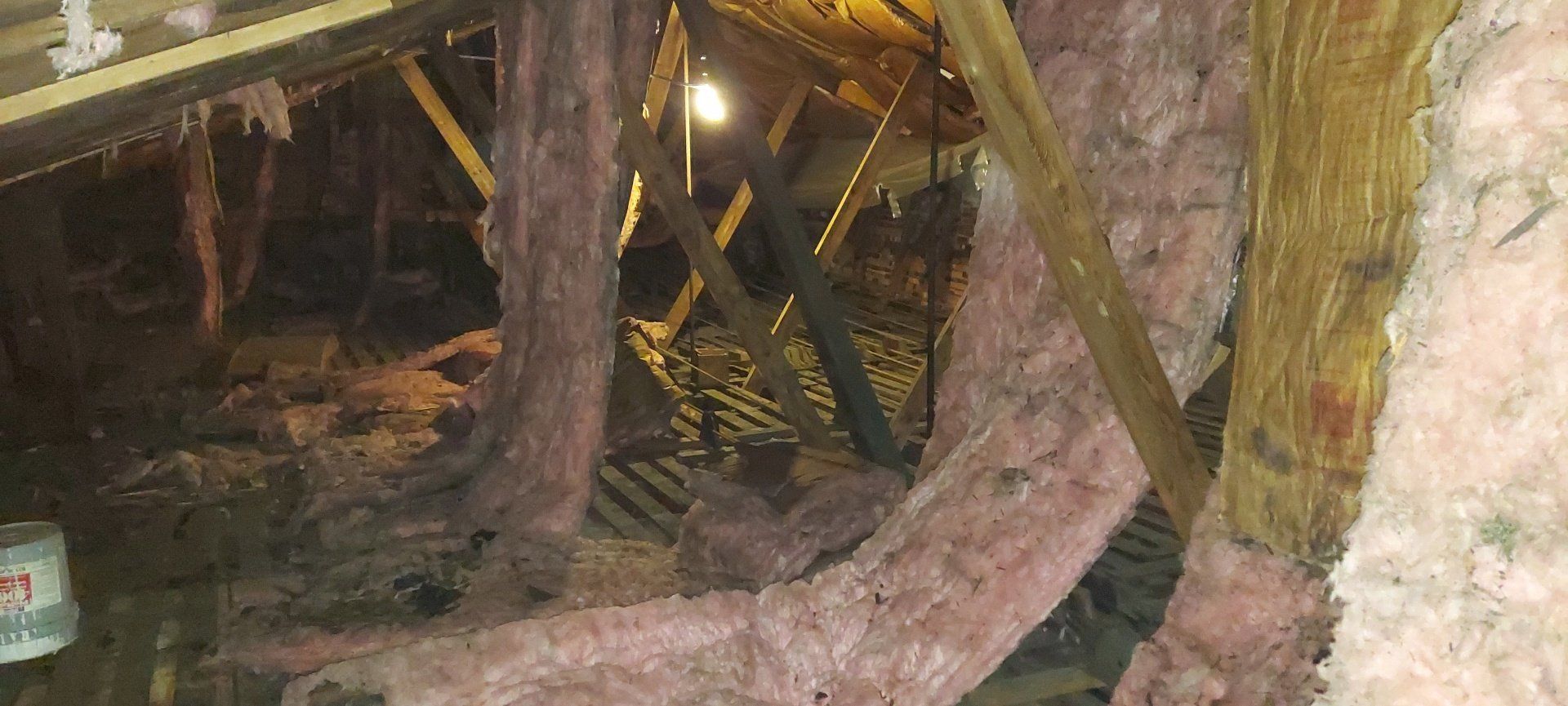 There is a lot of insulation in the attic of a house.