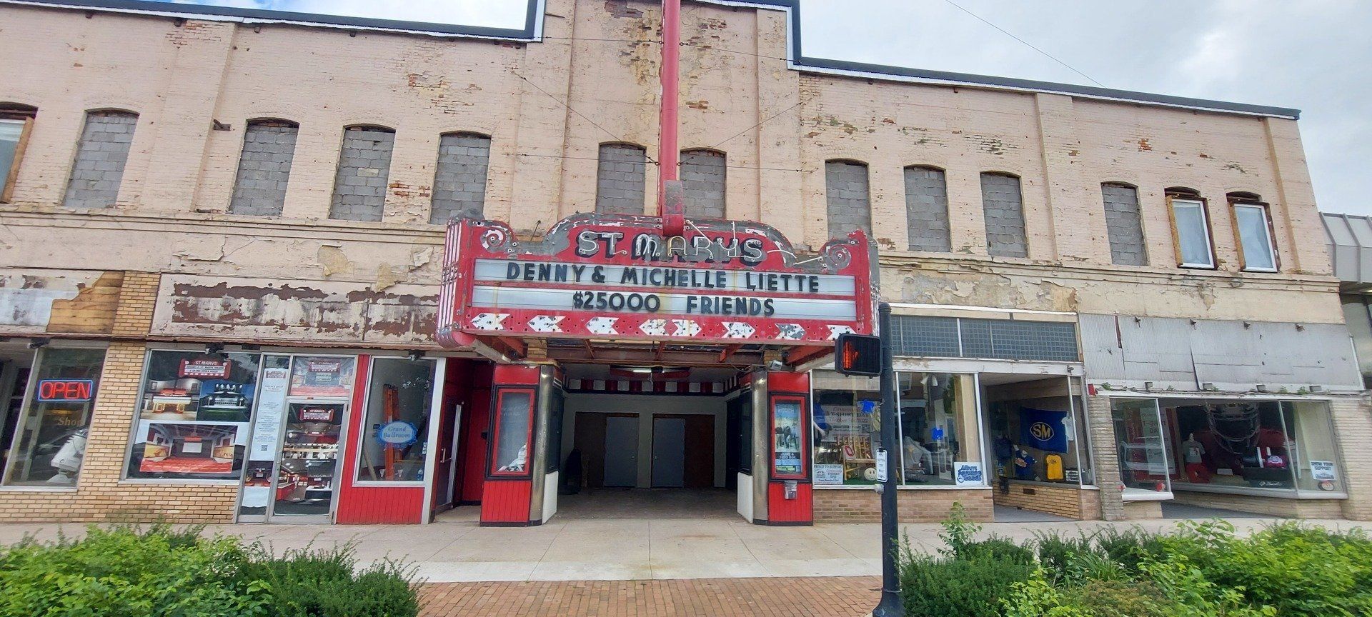 A large building with a red sign that says ' stadium ' on it.