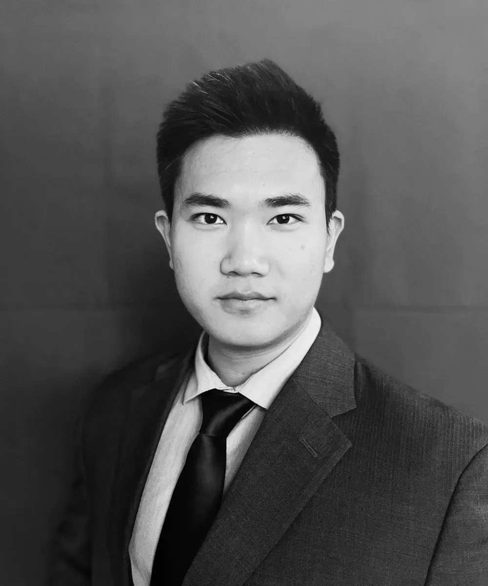 Man in a suit, looking directly at the camera. Black and white photo.