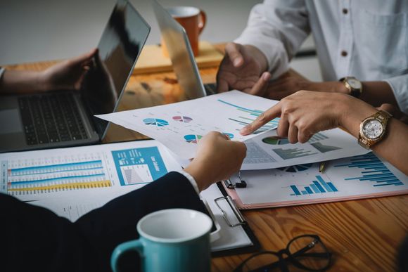 A group of women are sitting on a porch holding a baby.