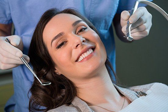 Smiling middle age woman at the dentist for preventative dental care