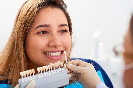 Smiling Latina woman in her 30's at the dentist for Dental Veneers