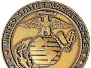 A united states marine corps coin with an eagle on it