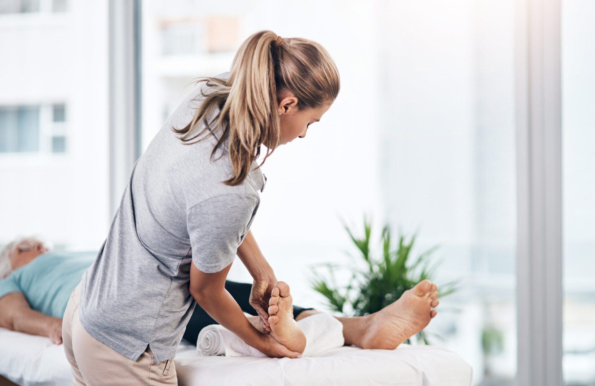 Senior Woman Being Treated By A Physiotherapist — Queen Creek, AZ — Medmotion Massage
