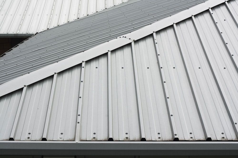 A Close Up Of A White Metal Roof On A Building — Gordo's Plumbing Service In Wagga Wagga, NSW