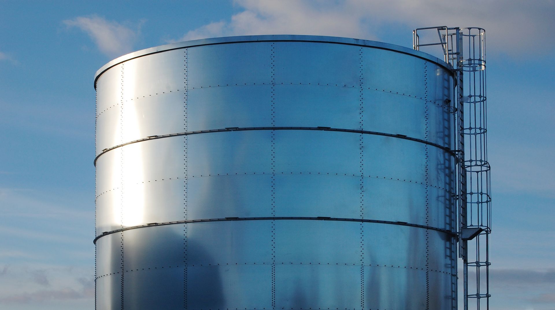 a large stainless steel water tank with a ladder attached to it