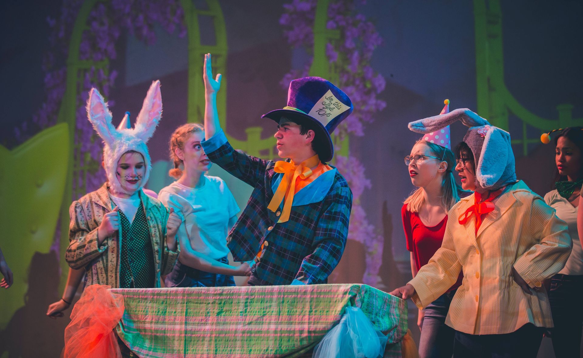 A group of young performers acting out Alice in Wonderland at Moss Performing Arts Academy