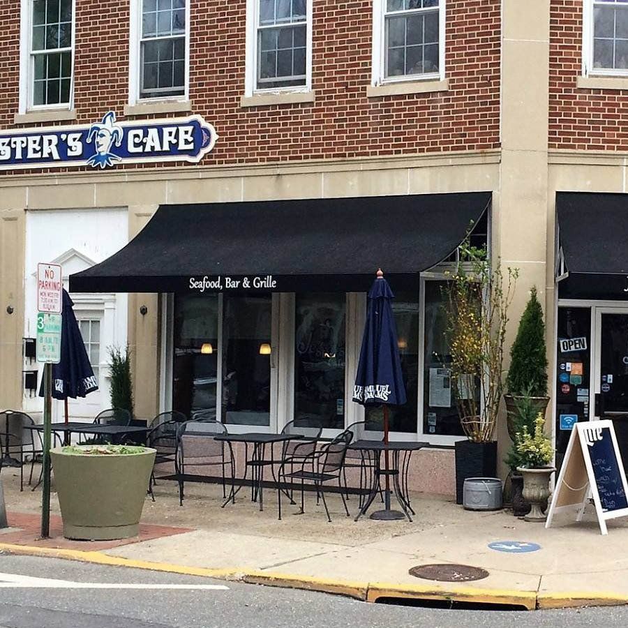 A brick building with a sign that says ' ster 's cafe ' on it