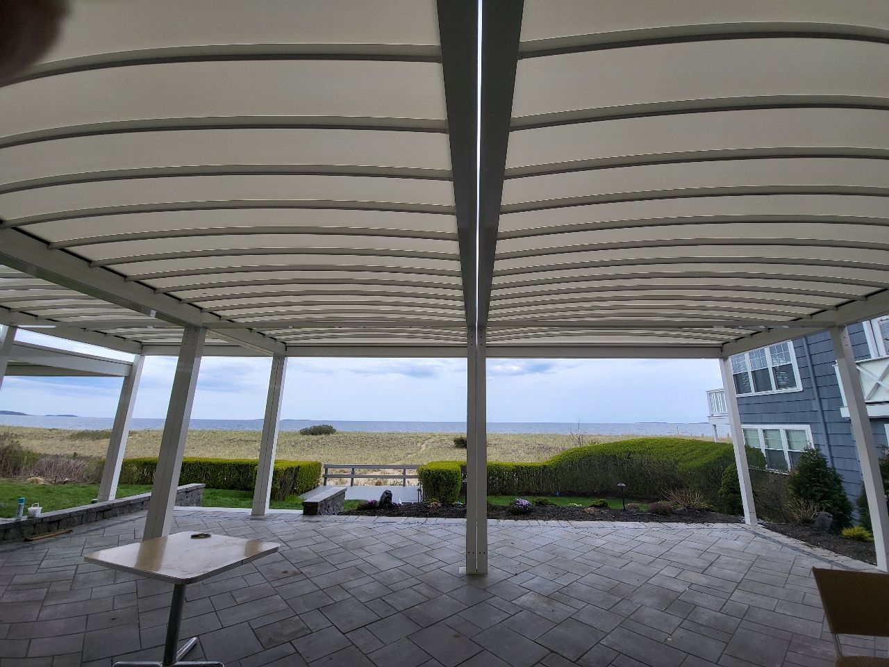 A covered patio with a view of the ocean - Freehold, NJ - Awning Design Inc