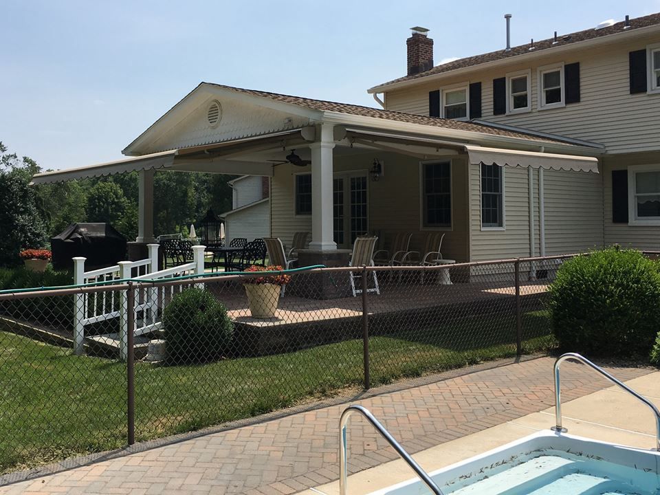 A large house with a swimming pool in front of it.