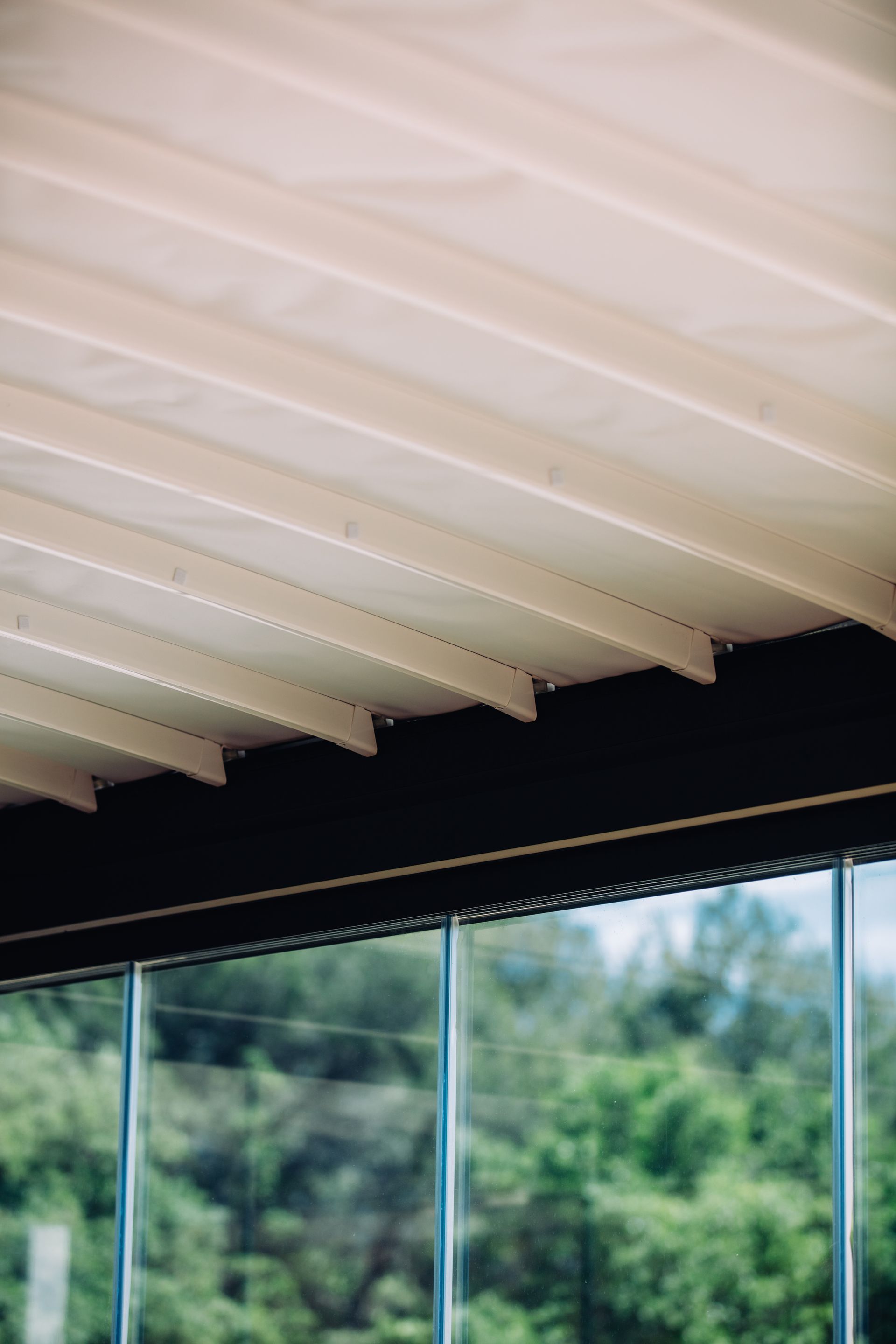 A close up of a wooden ceiling with a window in the background - Freehold, NJ - Awning Design Inc