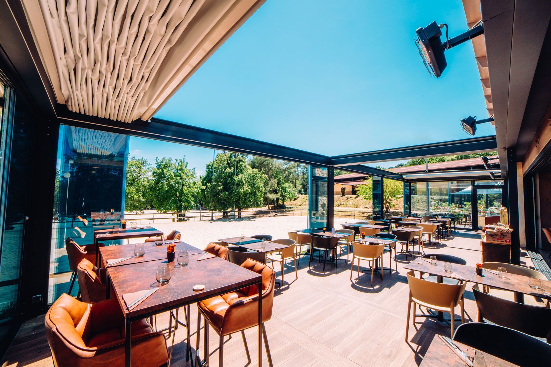 A restaurant with tables and chairs outside on a sunny day - Freehold, NJ - Awning Design Inc