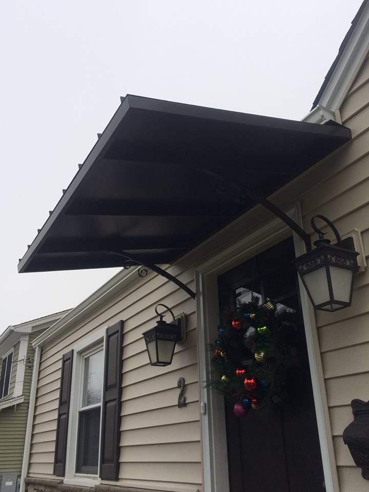 A house with a black awning over the front door