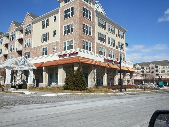 A large building with a store on the side of it - Freehold, NJ - Awning Design Inc