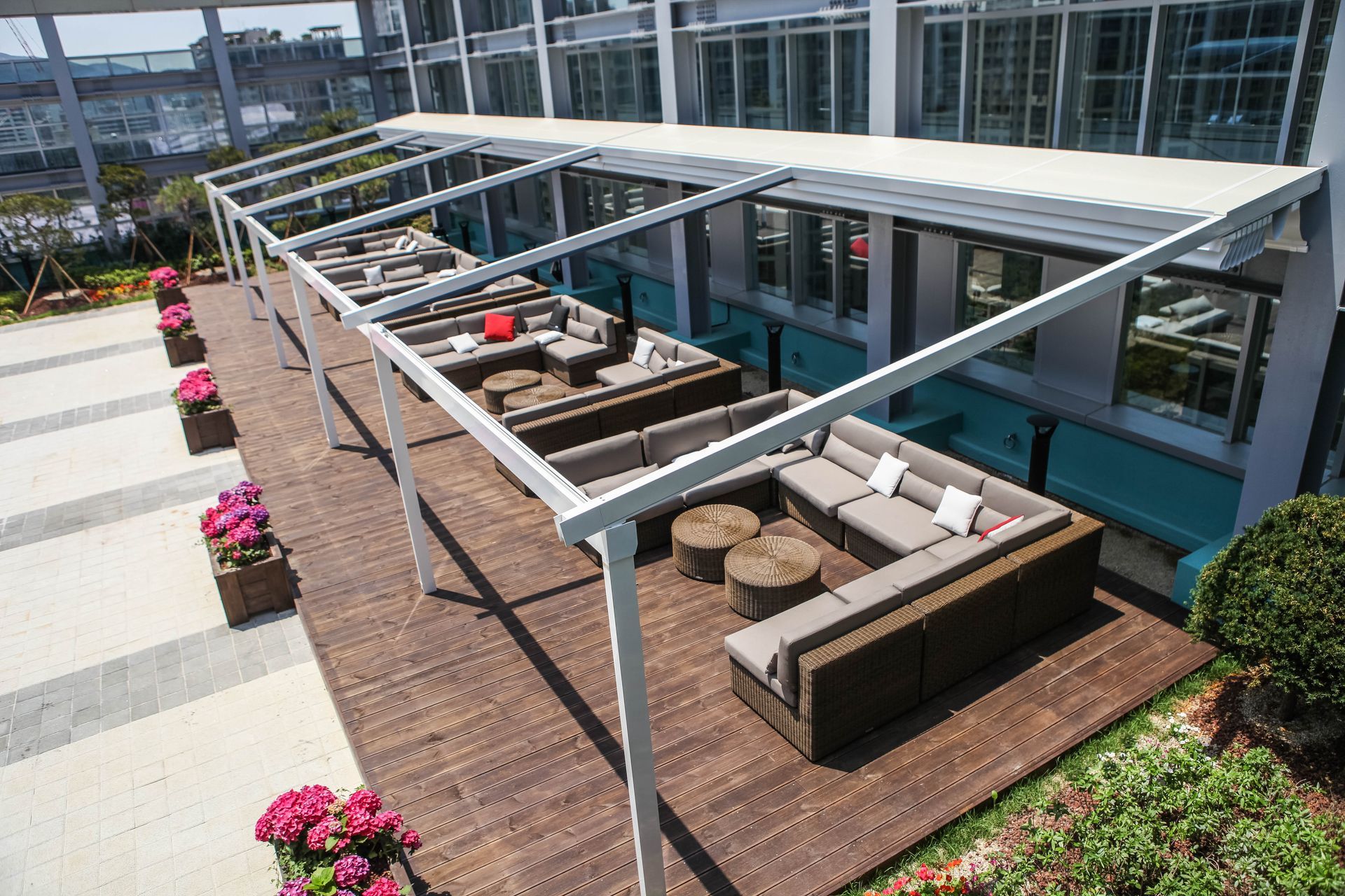 A large couch is sitting under a canopy on a wooden deck - Freehold, NJ - Awning Design Inc